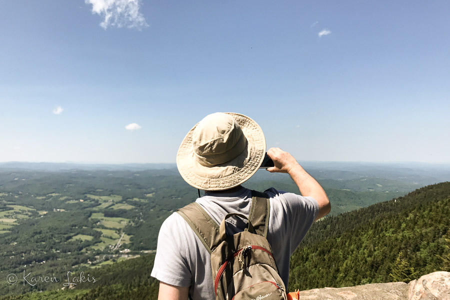 Greg taking a photo from a mountain vista