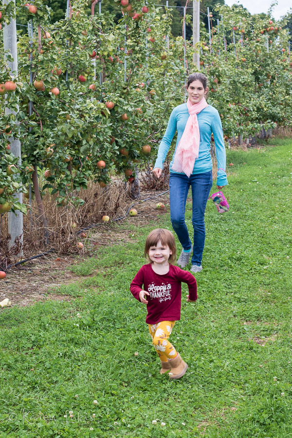 Ella running in the orchard