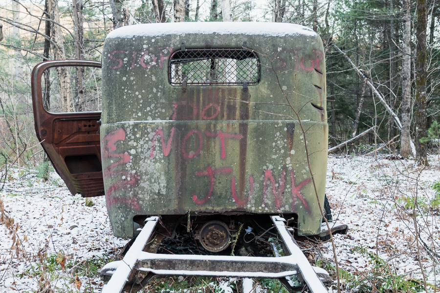 rusty truck with spray paint on back