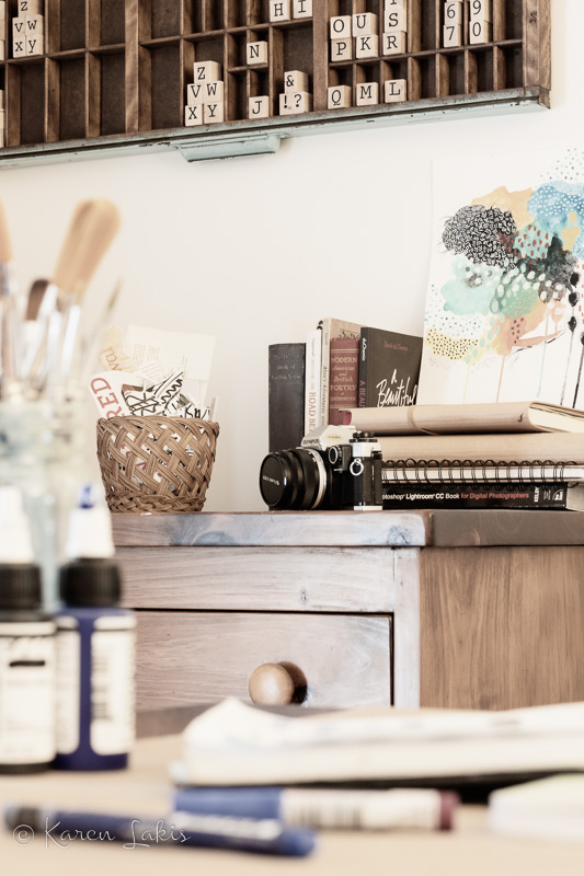 looking past desk to dresser with books